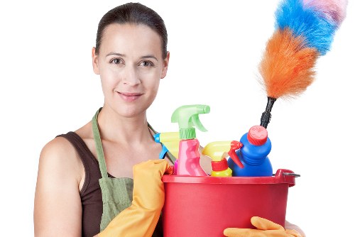 Cleaner placing a warning sign near a freshly mopped floor